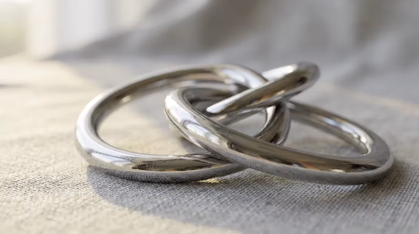 Macro photography of a silver metal wire puzzle on linen symbolizing strategic problem solving